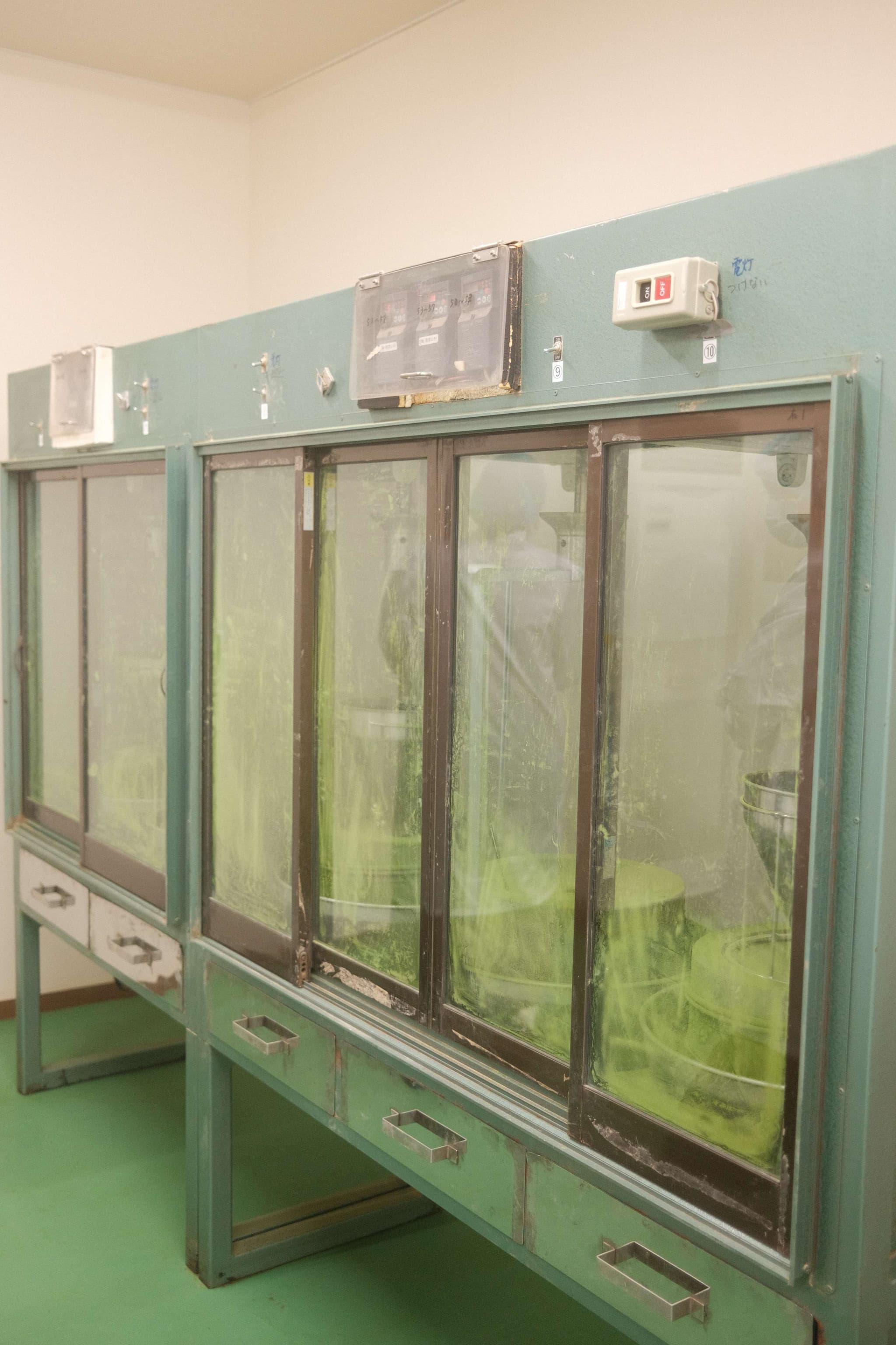 Japanese tea processing cabinets with green tea leaves